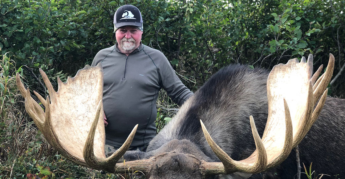 Man showcasing his moose hunt